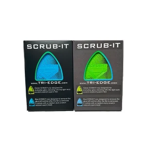 Tri-Edge Scrub-It packaging featuring green and blue variants with scratch-resistant pads for glass cleaning and adhesive removal.